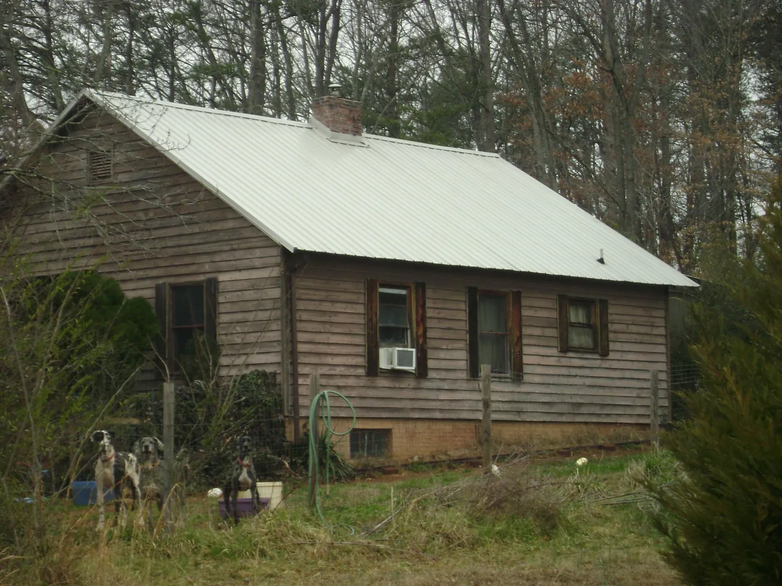 White metal roof on an old wood sided farmhouse, from a Metal Roof Installation job in Tendoy